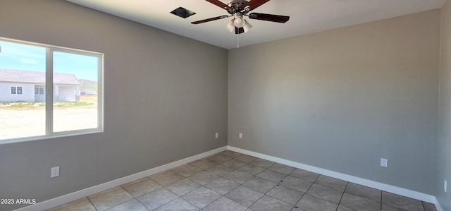 tiled empty room featuring ceiling fan and plenty of natural light