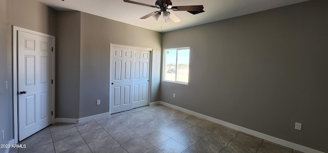 unfurnished bedroom with ceiling fan and light tile flooring