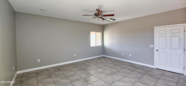 empty room with ceiling fan and light tile floors