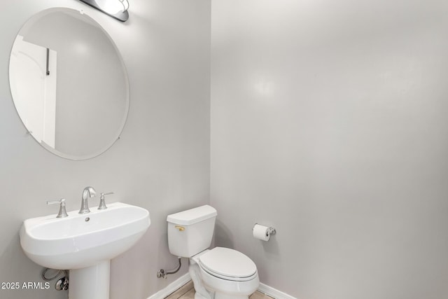 bathroom featuring sink and toilet