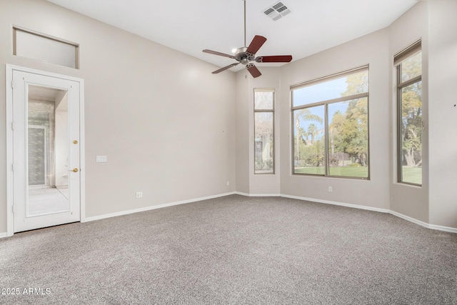 empty room with ceiling fan and carpet flooring