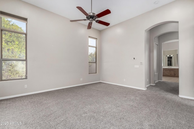 unfurnished room with ceiling fan and carpet flooring