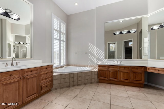 bathroom with vanity, tiled tub, and tile patterned floors