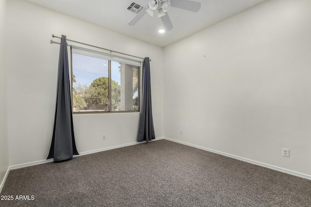 unfurnished room with dark colored carpet and ceiling fan