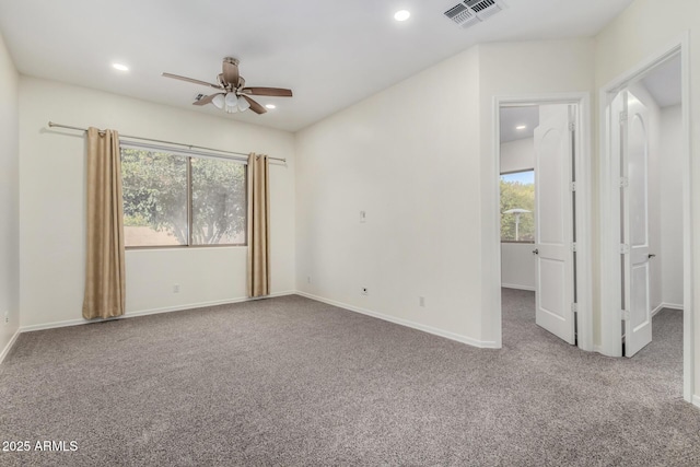 unfurnished room featuring carpet, plenty of natural light, and ceiling fan