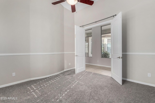 carpeted empty room featuring ceiling fan