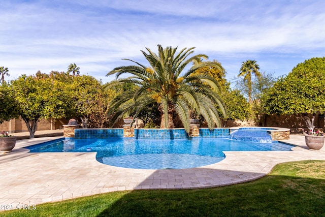 view of pool with an in ground hot tub, pool water feature, and a patio