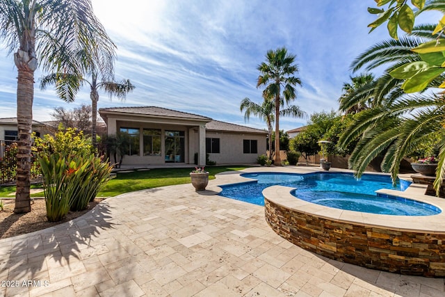 view of pool with a patio and an in ground hot tub