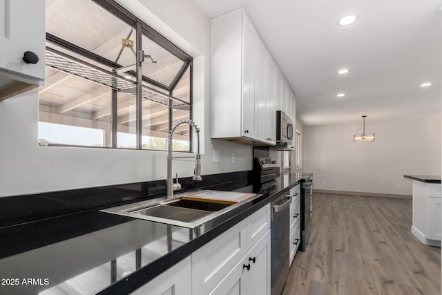 48451 N 27th Ave, New River, AZ 85087 - kitchen with dark countertops, stainless steel appliances, a sink, white cabinetry, and recessed lighting
