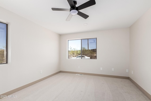 48451 N 27th Ave, New River, AZ 85087 - spare room featuring light colored carpet, a ceiling fan, and baseboards
