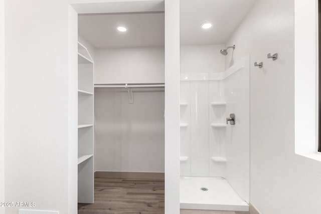 48451 N 27th Ave, New River, AZ 85087 - full bathroom featuring a shower, wood finished floors, baseboards, recessed lighting, and a walk in closet