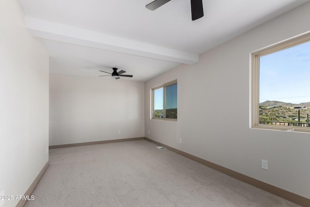 48451 N 27th Ave, New River, AZ 85087 - empty room featuring ceiling fan, light carpet, baseboards, and beamed ceiling