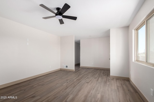 48451 N 27th Ave, New River, AZ 85087 - unfurnished room featuring wood finished floors, baseboards, and a ceiling fan