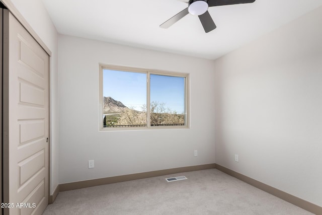 48451 N 27th Ave, New River, AZ 85087 - unfurnished bedroom with light colored carpet, baseboards, a closet, and ceiling fan