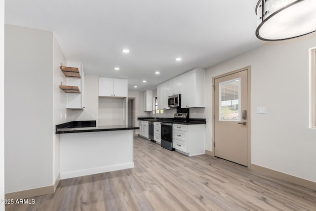 48451 N 27th Ave, New River, AZ 85087 - kitchen with stainless steel appliances, dark countertops, open shelves, white cabinetry, and light wood finished floors
