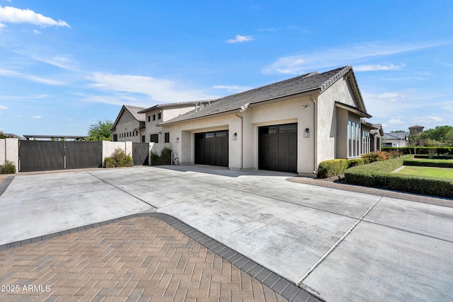 2652 E Pelican Ct, Gilbert, AZ 85297 - view of home's exterior featuring concrete driveway, an attached garage, stucco siding, and a tile roof