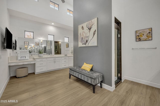 2652 E Pelican Ct, Gilbert, AZ 85297 - full bath featuring wood finished floors, vanity, a high ceiling, and a shower