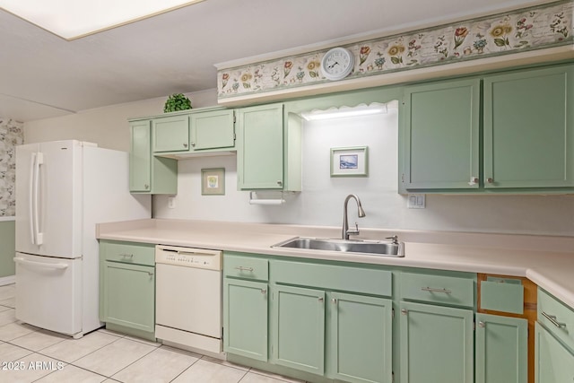 kitchen featuring white appliances, green cabinets, sink, and light tile patterned floors