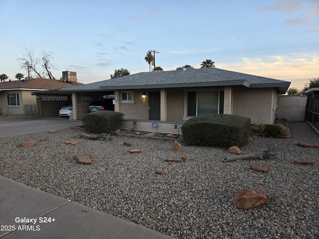 view of front facade with a carport and central air condition unit