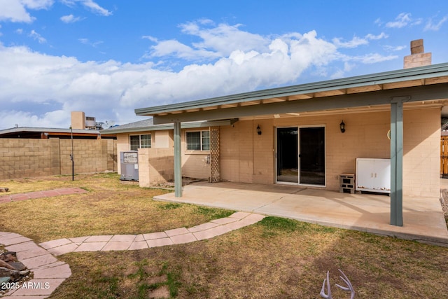 back of house featuring a yard and a patio area