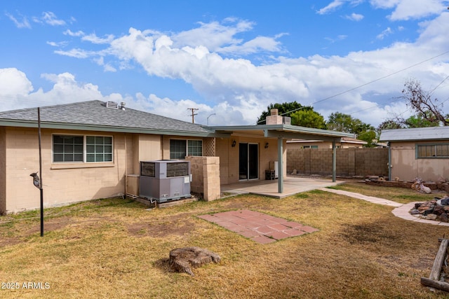 back of property featuring a yard, central AC, and a patio