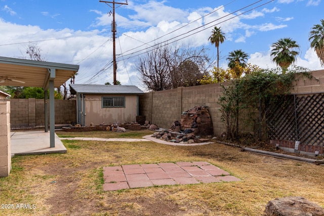 view of yard featuring a storage shed and a patio