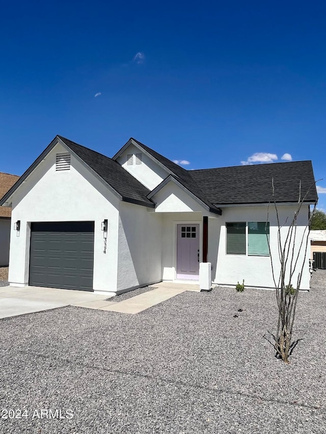 view of front of house with a garage and central AC unit