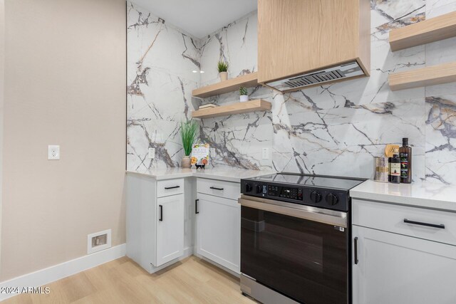 kitchen featuring light hardwood / wood-style flooring, white cabinetry, pendant lighting, and sink