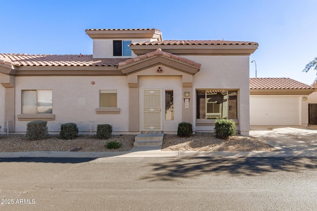 mediterranean / spanish home with a garage