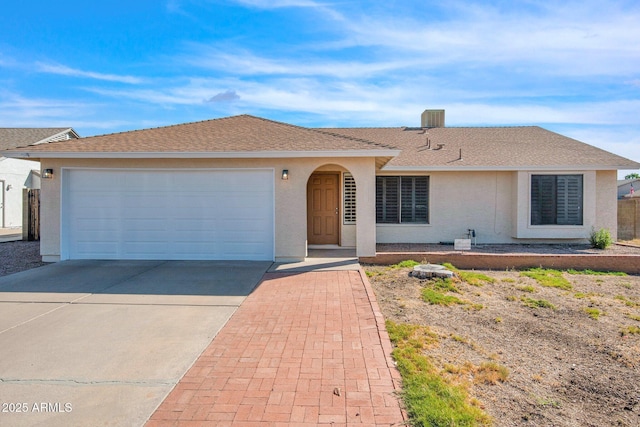 ranch-style home with stucco siding, driveway, a shingled roof, and a garage