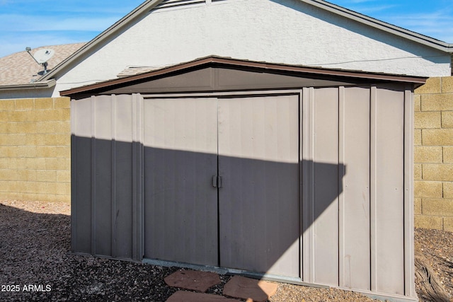 view of shed with fence