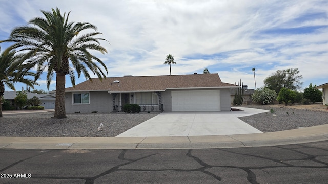 ranch-style house with concrete driveway, a porch, and a garage