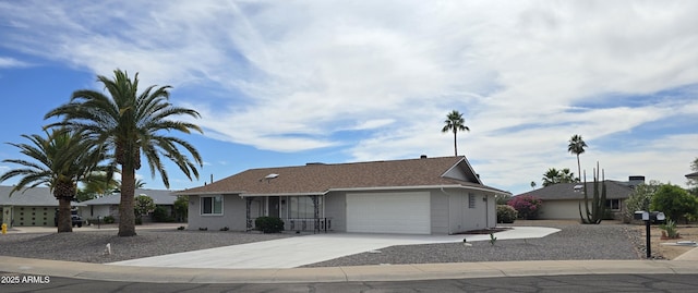 view of front of property with concrete driveway and an attached garage