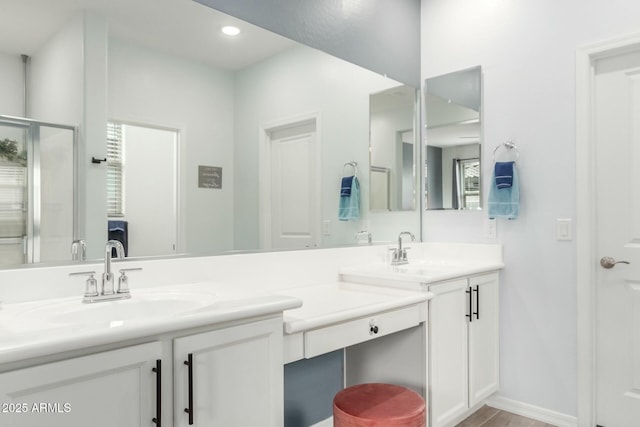 bathroom with walk in shower and vanity