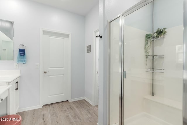 bathroom featuring vanity, an enclosed shower, and hardwood / wood-style floors