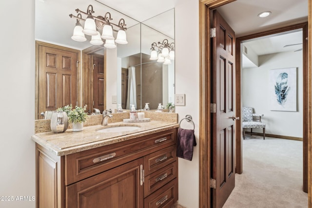 full bath with vanity and baseboards