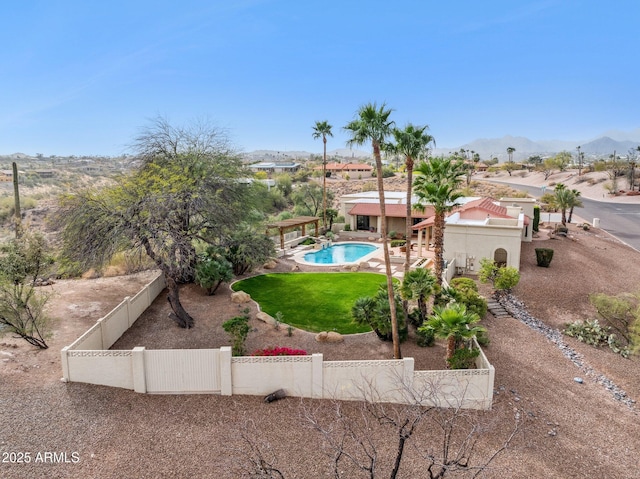 view of yard featuring a fenced backyard, a mountain view, an outdoor pool, and a patio