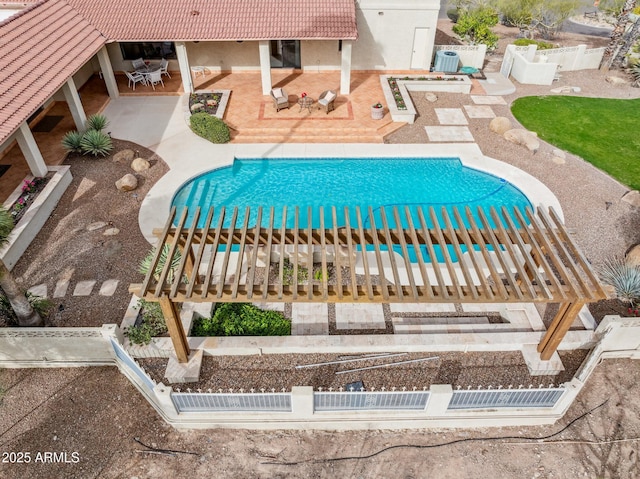 view of pool with a patio and fence