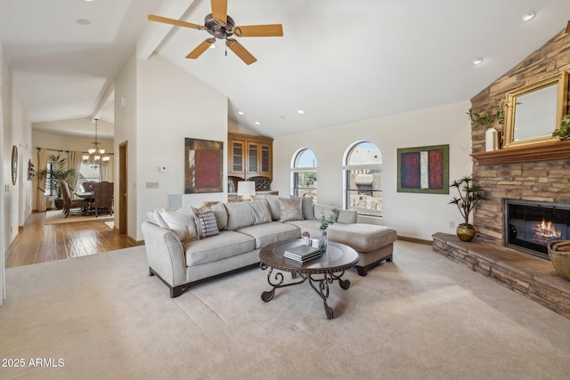 carpeted living room with beam ceiling, a stone fireplace, wood finished floors, high vaulted ceiling, and baseboards