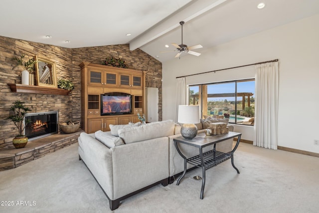 living room with a fireplace, light colored carpet, lofted ceiling with beams, ceiling fan, and baseboards