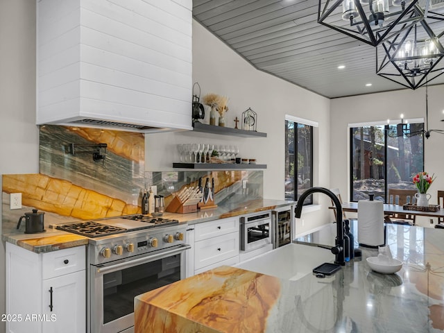 1137 Timbernook Xing, Williams, AZ 86046 - bar area with appliances with stainless steel finishes, custom range hood, a chandelier, a sink, and backsplash