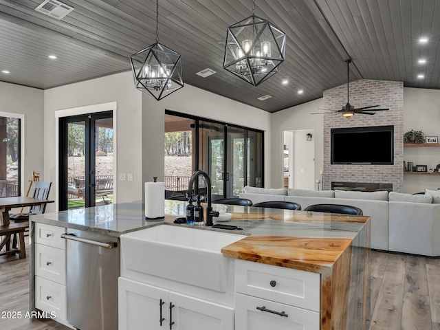 1137 Timbernook Xing, Williams, AZ 86046 - kitchen with french doors, a sink, vaulted ceiling, light wood-type flooring, and recessed lighting