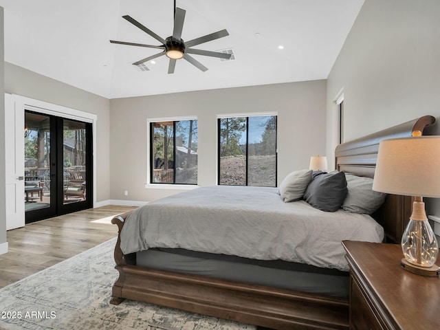 1137 Timbernook Xing, Williams, AZ 86046 - bedroom with access to outside, wood finished floors, multiple windows, baseboards, and high vaulted ceiling