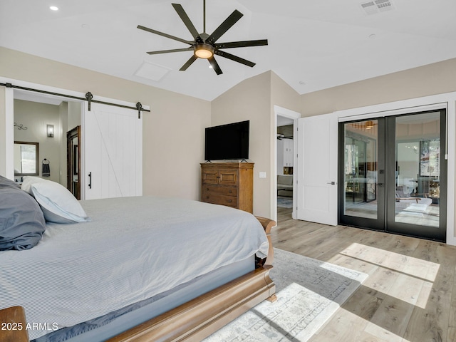 1137 Timbernook Xing, Williams, AZ 86046 - bedroom with a barn door, access to exterior, lofted ceiling, light wood finished floors, and french doors