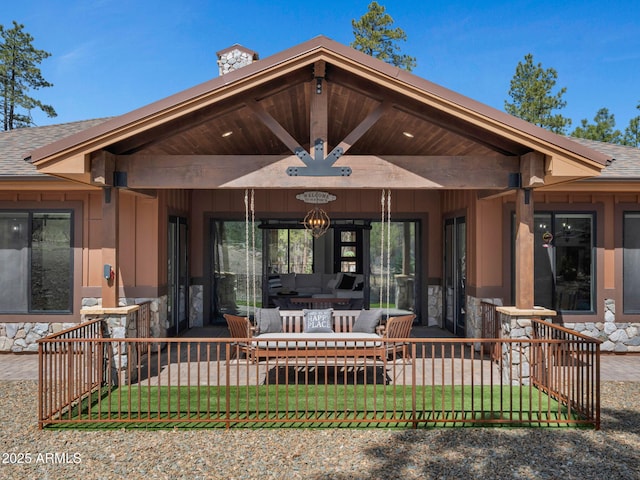 1137 Timbernook Xing, Williams, AZ 86046 - back of house featuring stone siding, outdoor lounge area, a shingled roof, and a chimney