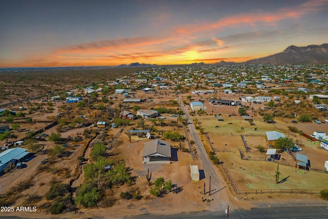 aerial view at dusk featuring a residential view and a mountain view