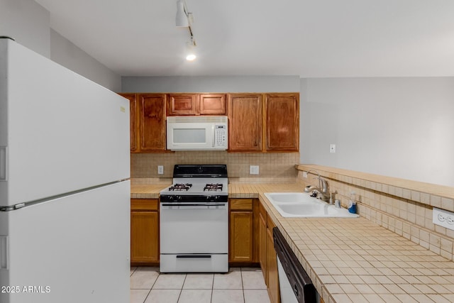125 S 56th St Unit 124, Mesa, AZ 85206 - kitchen with white appliances, a sink, decorative backsplash, and brown cabinetry
