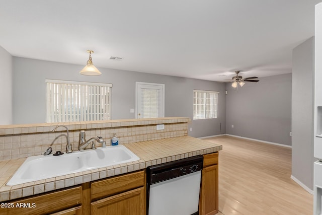 125 S 56th St Unit 124, Mesa, AZ 85206 - kitchen with dishwasher, a sink, ceiling fan, light wood finished floors, and brown cabinets