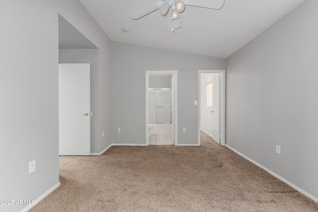 125 S 56th St Unit 124, Mesa, AZ 85206 - unfurnished bedroom featuring carpet, vaulted ceiling, baseboards, ensuite bath, and a ceiling fan