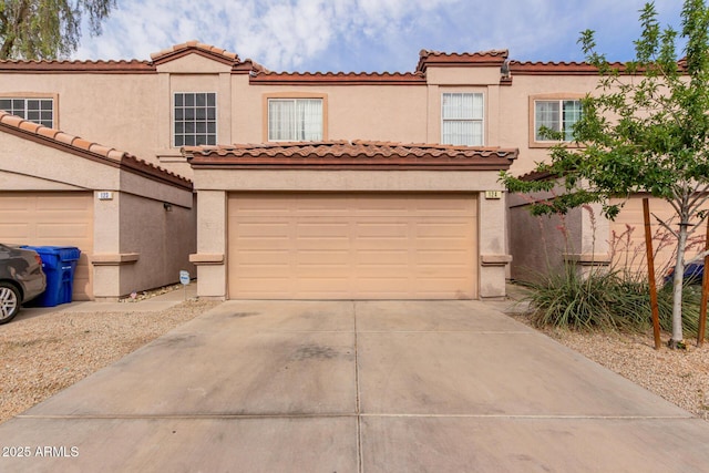 125 S 56th St Unit 124, Mesa, AZ 85206 - view of front of property with a garage, driveway, stucco siding, and a tile roof